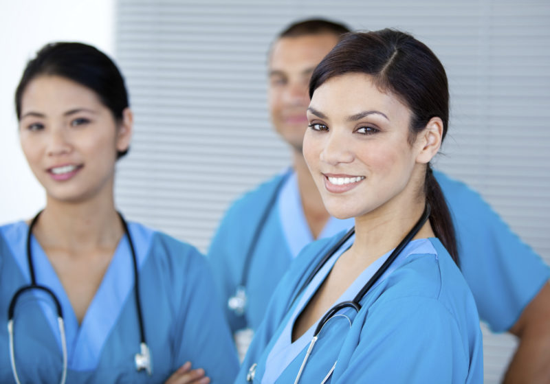 Happy doctor colleagues looking at the camera